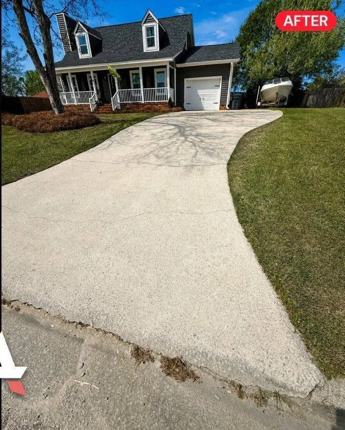 Curved concrete driveway after pressure washing with the after label from a recent Augusta job