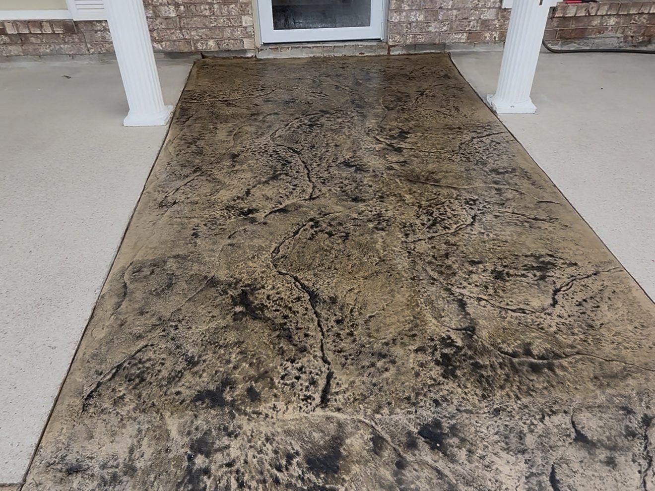 Stamped concrete entry walkway installed by Anything Exterior