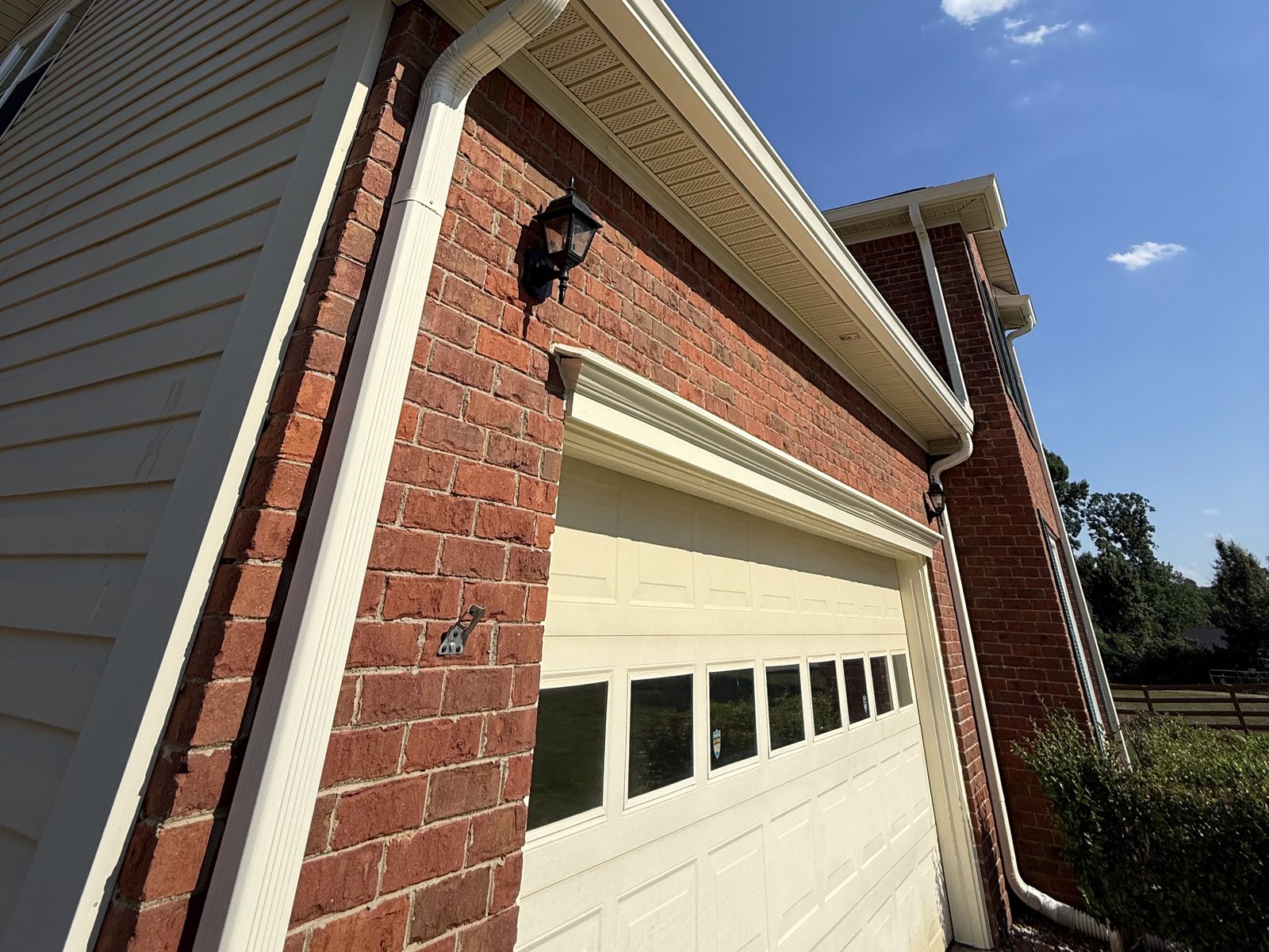 Soft-washed siding, soffits and gutters on a brick home